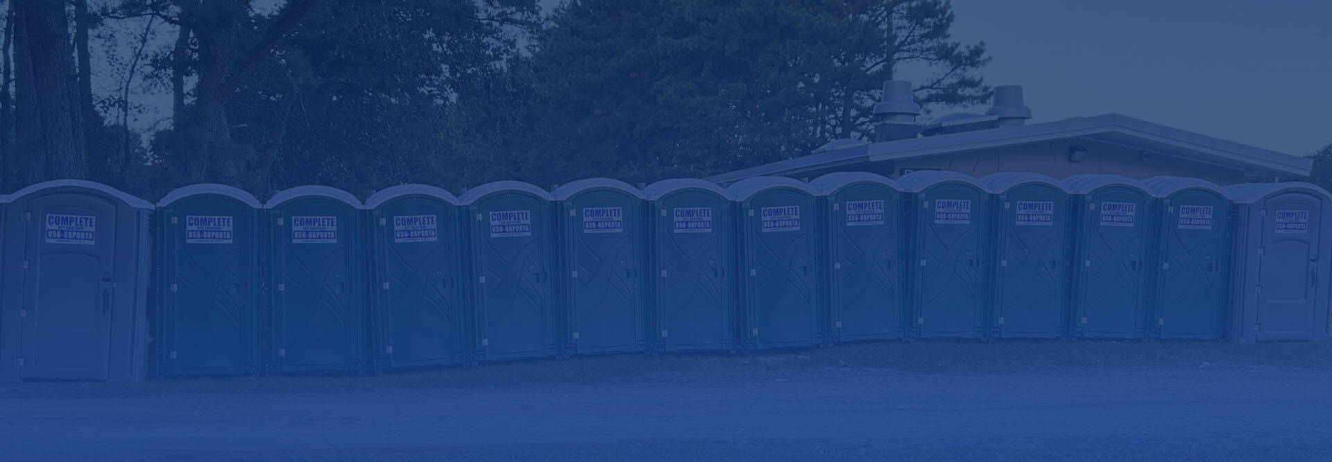 row of Complete Site Solutions portable toilets