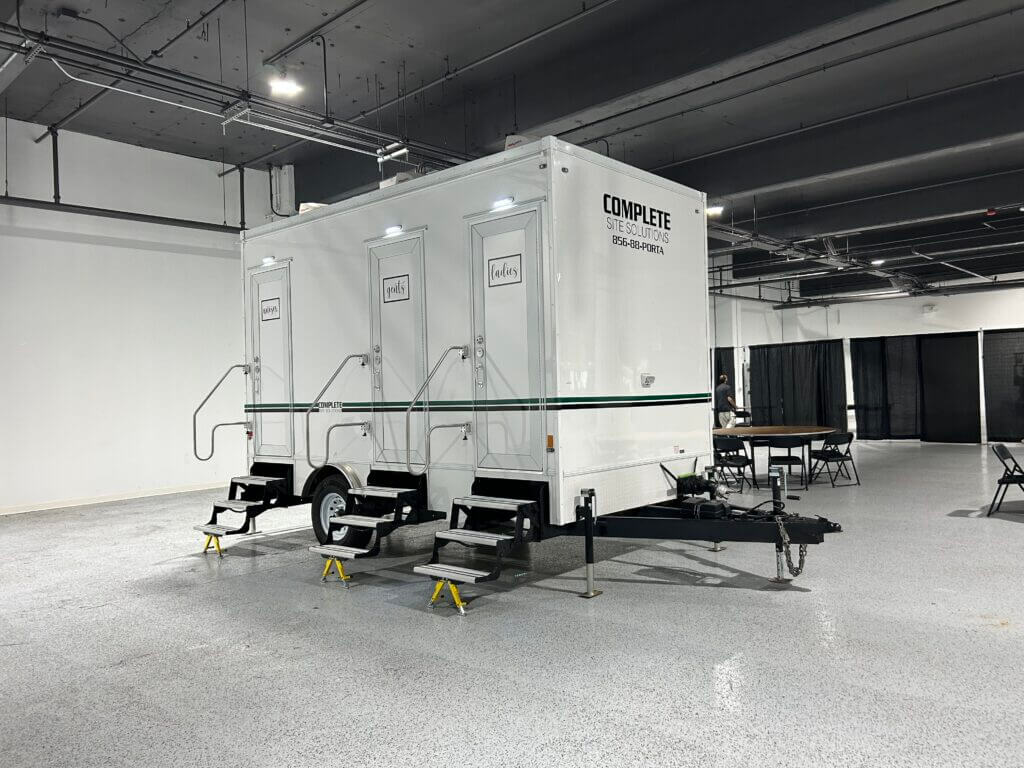Complete Site Solutions restroom trailer parked inside for event
