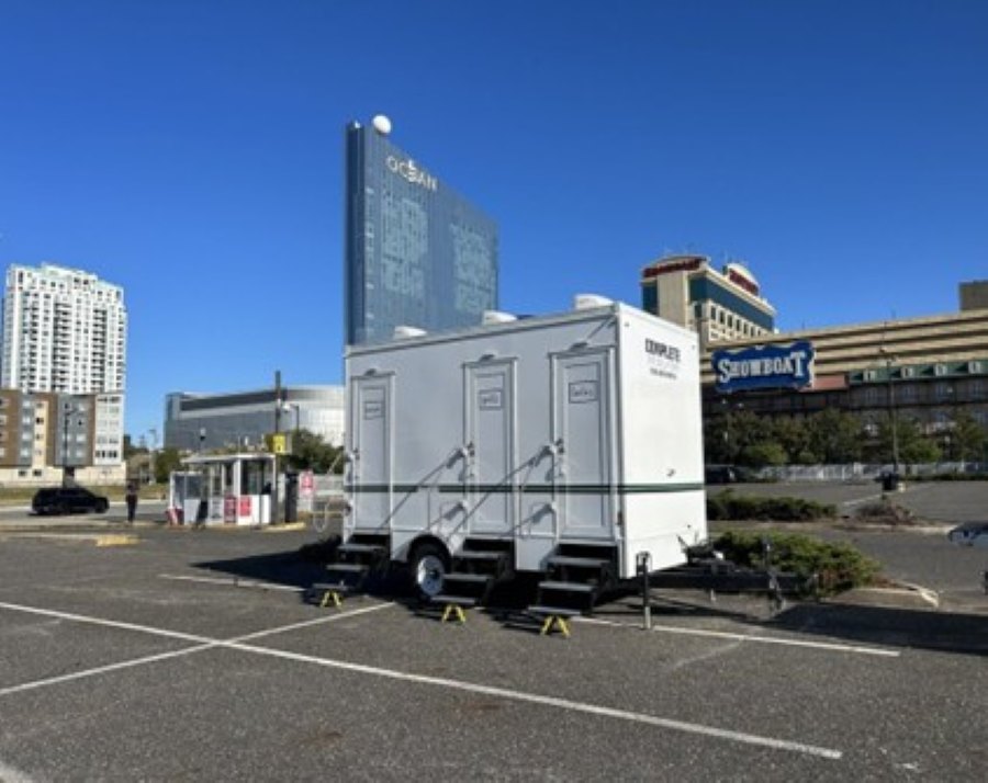 Portable toilet delivery truck at commercial job site in Moorestown, NJ