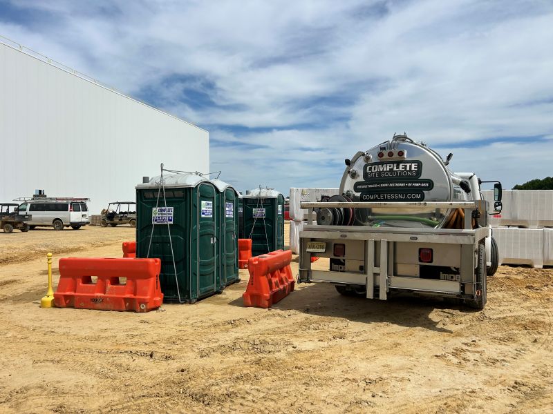 Portable toilets on a construction site with sanitation service equipment in New Jersey