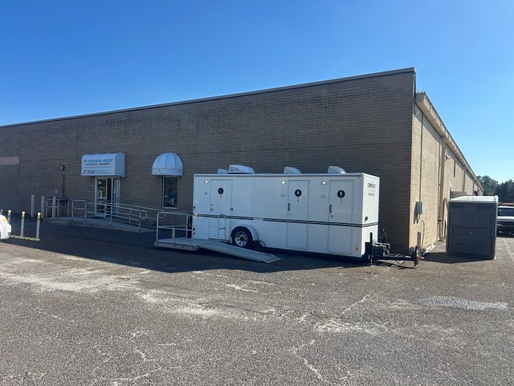 ADA-accessible restroom trailer outside fitness facility parking lot in Blackwood, NJ