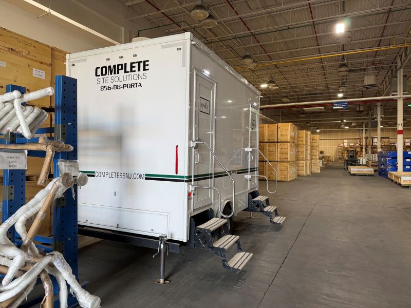 Restroom trailer positioned inside warehouse distribution facility in Williamstown, NJ